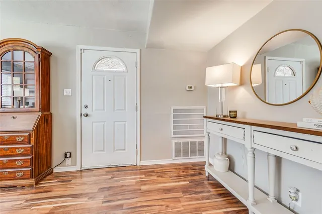 a spacious bathroom with a mirror a sink and a mirror