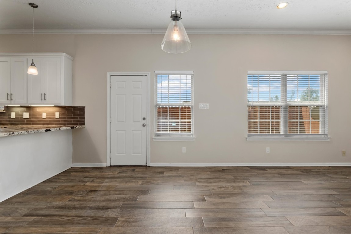 7036 West 43rd Street Houston, TX 77092 - Photo 11 of 28 a view of an empty room with wooden floor and a window