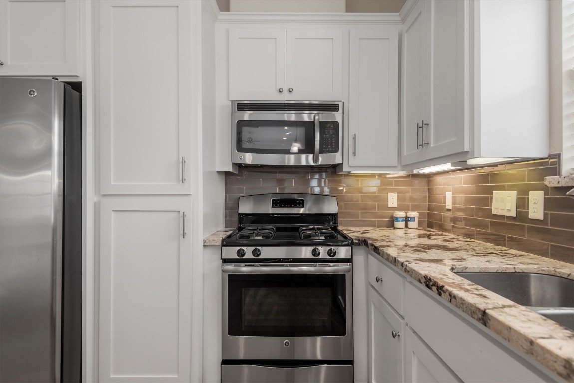 7036 West 43rd Street Houston, TX 77092 - Photo 15 of 28 a kitchen with granite countertop a stove and a sink