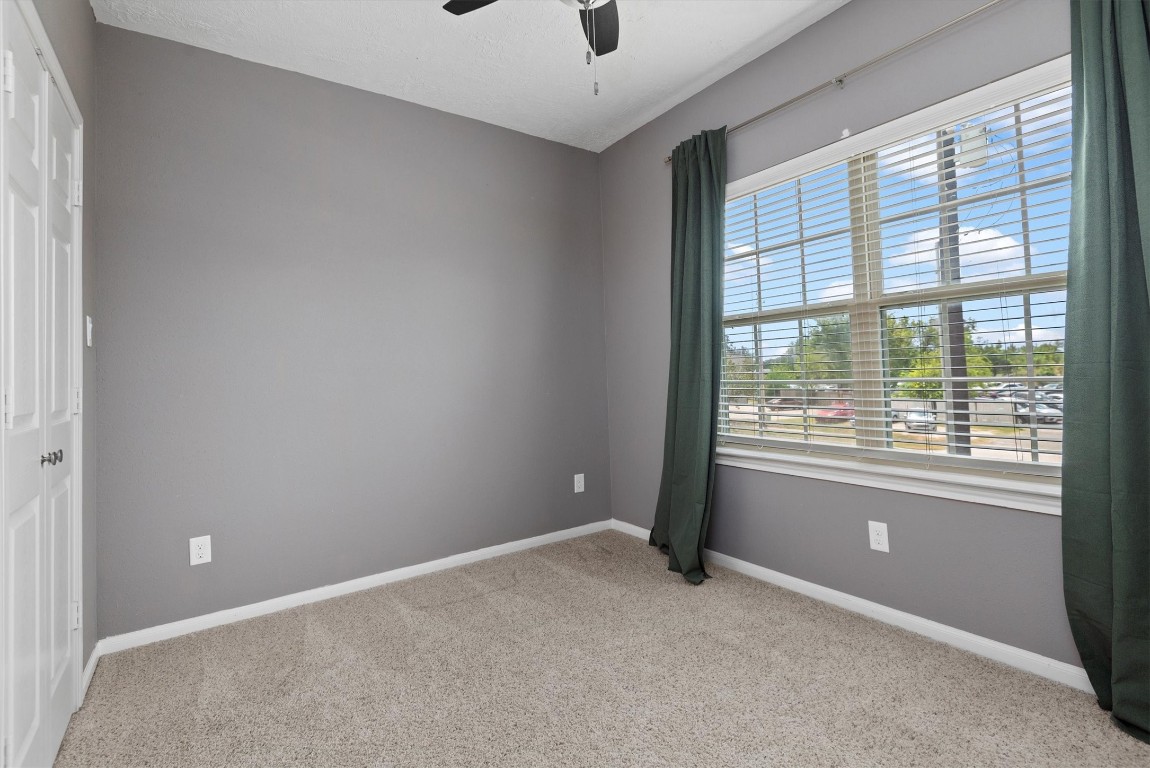 7036 West 43rd Street Houston, TX 77092 - Photo 23 of 28 an empty room with windows and ceiling fan