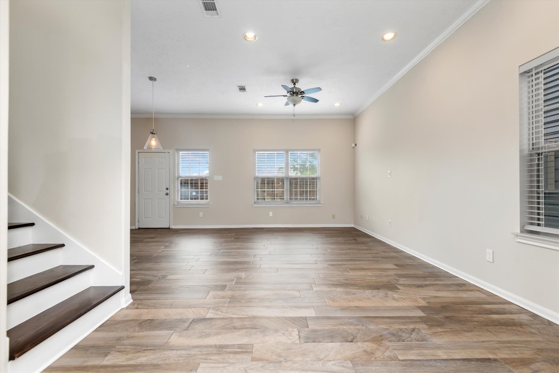 7036 West 43rd Street Houston, TX 77092 - Photo 6 of 28 an empty room with wooden floor and windows