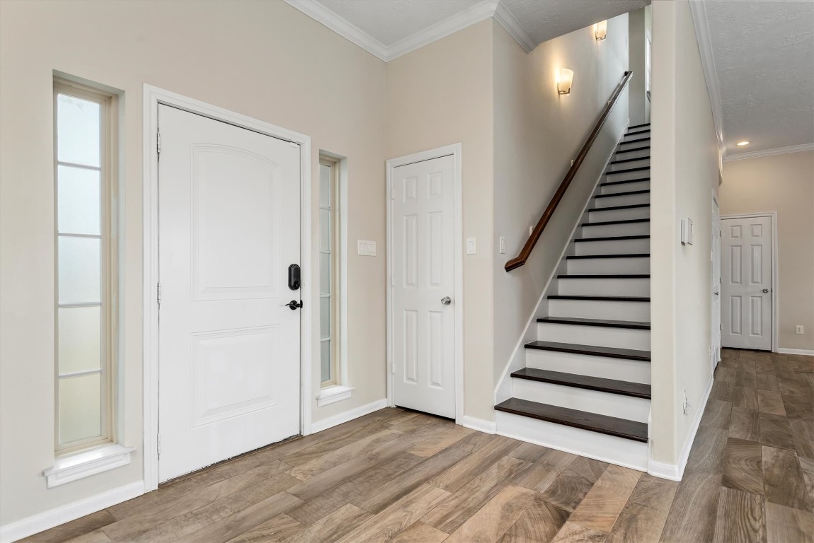 7036 West 43rd Street Houston, TX 77092 - Photo 8 of 28 a view of entryway with wooden floor