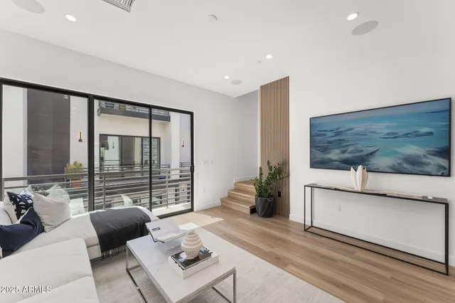 a dining room with stainless steel appliances kitchen island granite countertop a dining table chairs and view living room