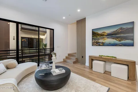 a living room with a couch and a wooden floor