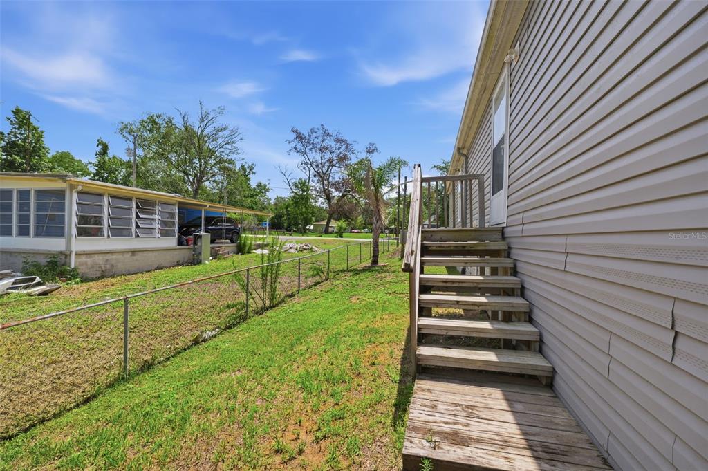 3183 Cedley Road Dade City, FL 33523 - Photo 19 of 48 a view of a house with wooden fence