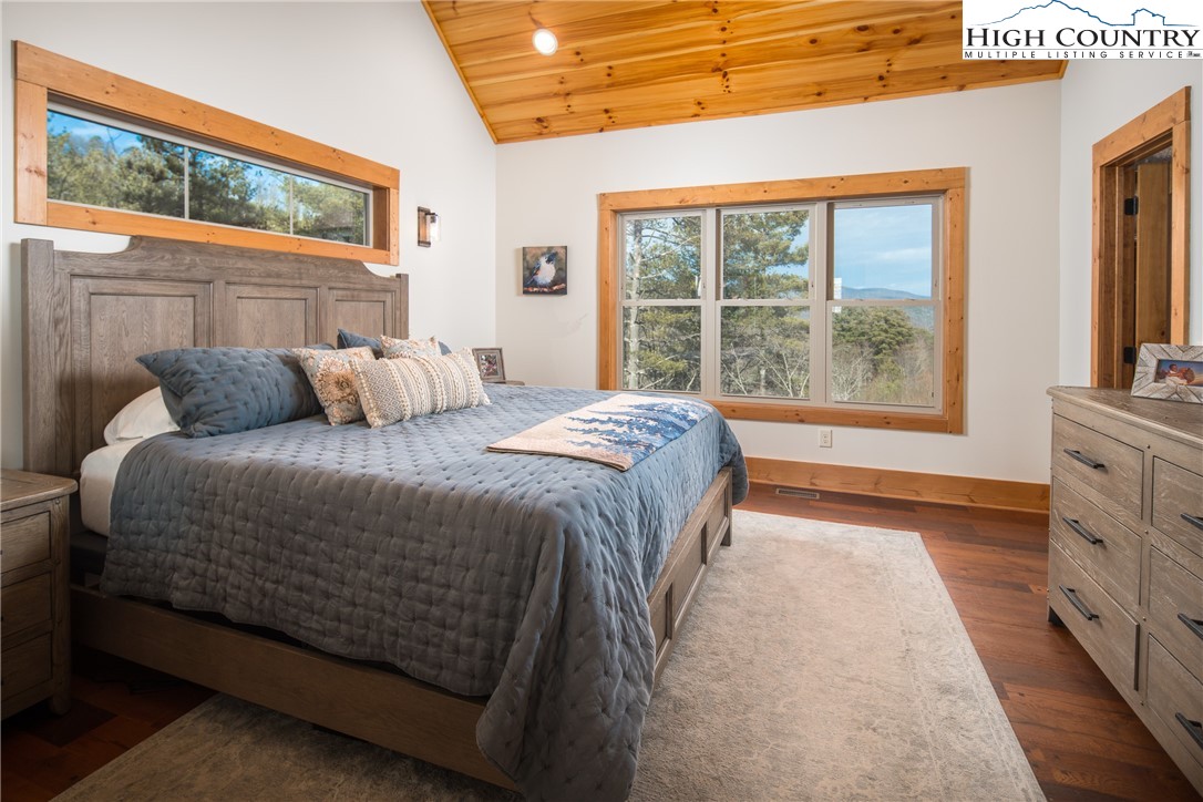 765 Pepperroot Road Boone, NC 28607 - Photo 14 of 35 a bedroom with a large bed and a large window