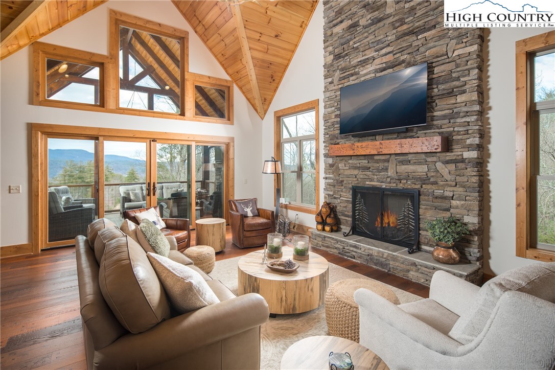 765 Pepperroot Road Boone, NC 28607 - Photo 2 of 35 a living room with furniture a flat screen tv and a fireplace