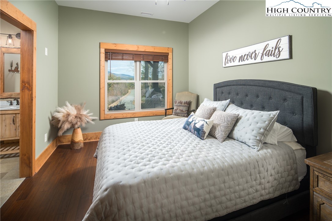 765 Pepperroot Road Boone, NC 28607 - Photo 22 of 35 a bedroom with a bed and a large window