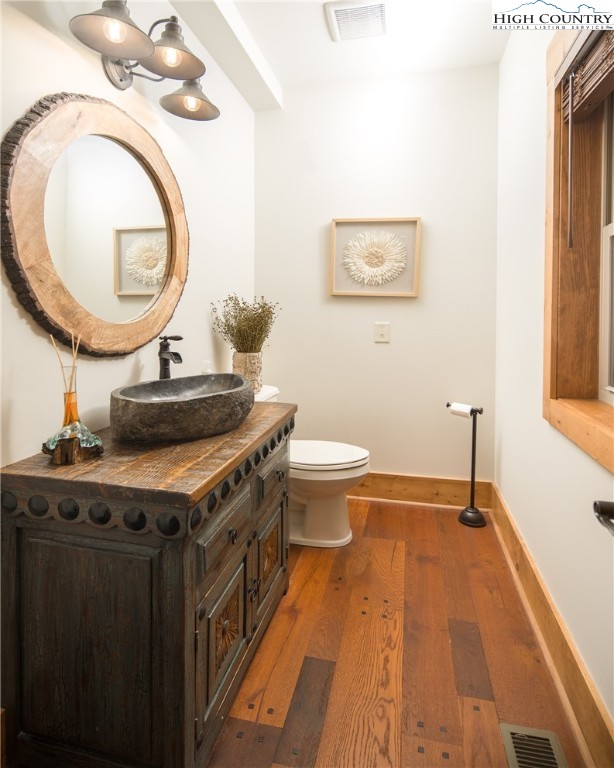 765 Pepperroot Road Boone, NC 28607 - Photo 6 of 35 a bathroom with a sink a toilet and a mirror