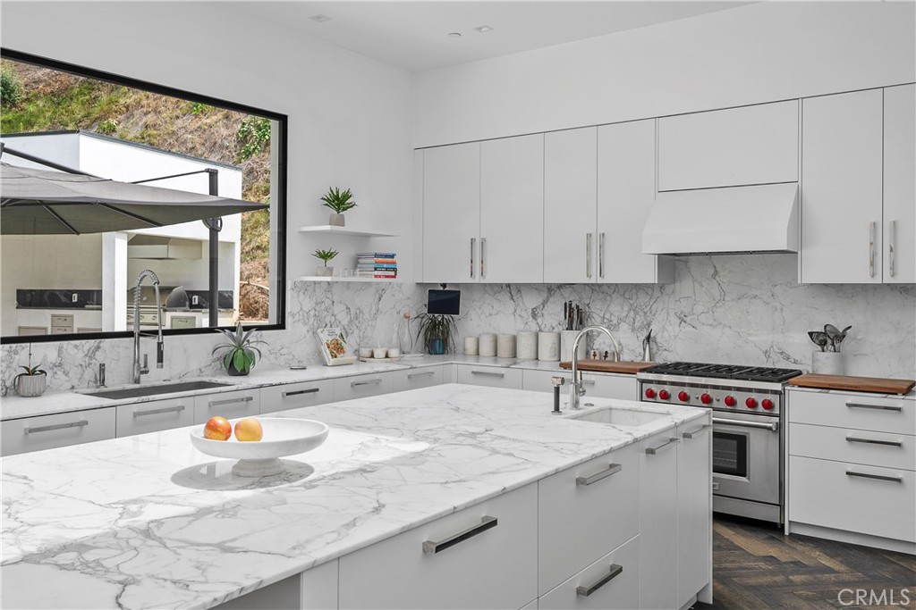 9924 Liebe Drive Beverly Hills, CA 90210 - Photo 29 of 65 a kitchen with stainless steel appliances granite countertop a sink and white cabinets