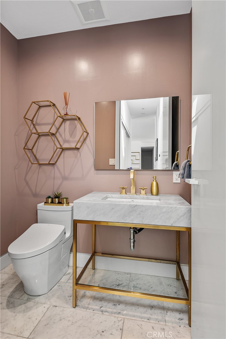 9924 Liebe Drive Beverly Hills, CA 90210 - Photo 43 of 65 a bathroom with a sink mirror vanity and toilet