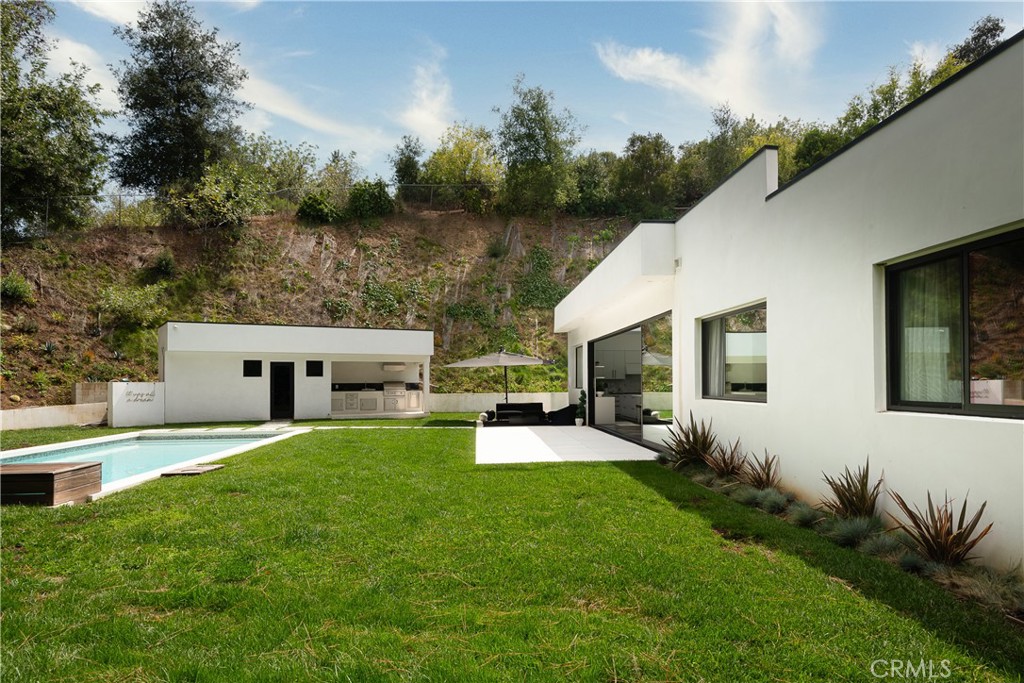 9924 Liebe Drive Beverly Hills, CA 90210 - Photo 8 of 65 a front view of house with yard and trees in the background