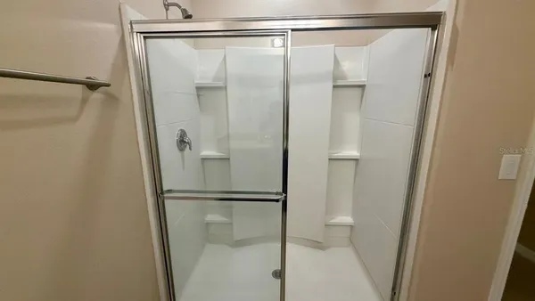 a bathroom with a glass shower door