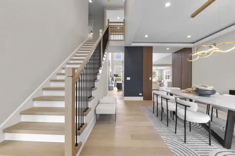 a view of a hallway with wooden floor and staircase