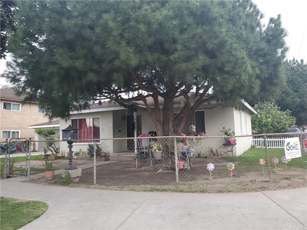 a view of a house with a yard and table or chairs