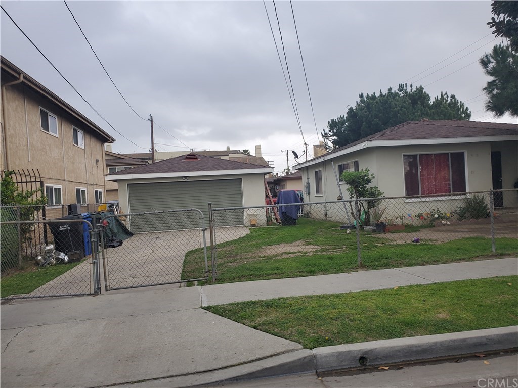 7913 Howe Street Paramount, CA 90723 - Photo 17 of 17 a front view of a house with garden