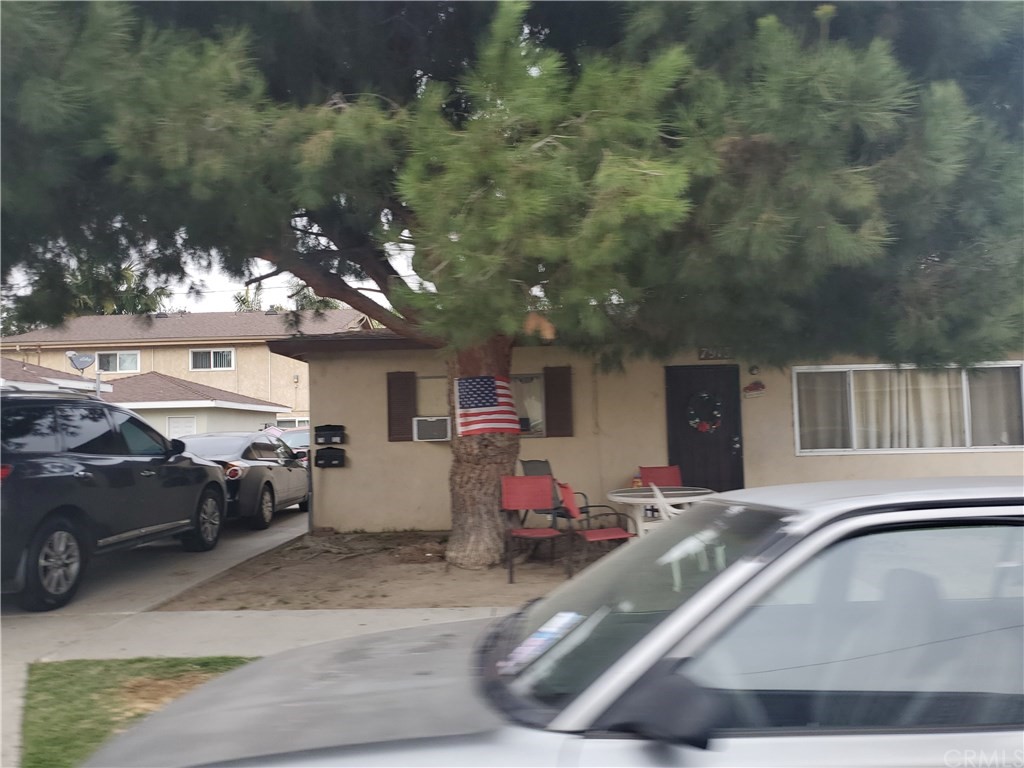 7913 Howe Street Paramount, CA 90723 - Photo 5 of 17 a view of a cars park in front of house