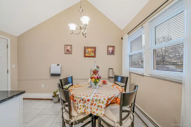 a view of a dining room with furniture and chandelier