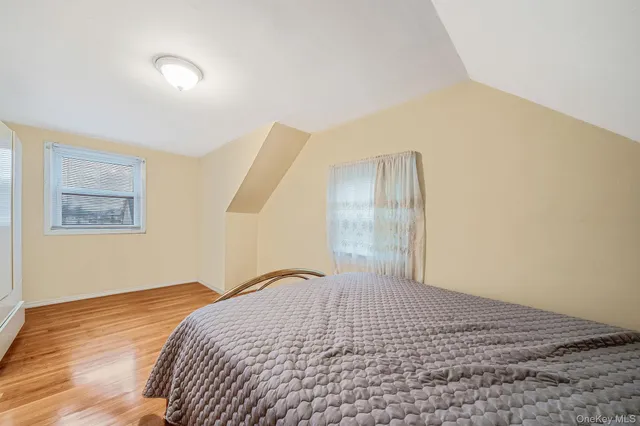 a view of a big room with wooden floor and windows