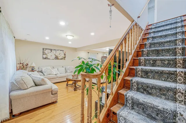 a living room with furniture and stairs