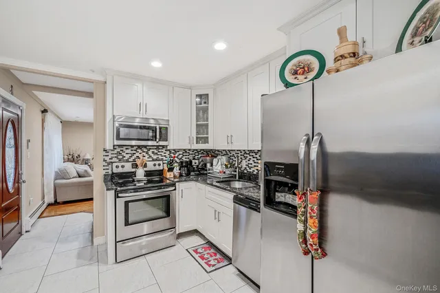 a kitchen with a sink cabinets and stainless steel appliances