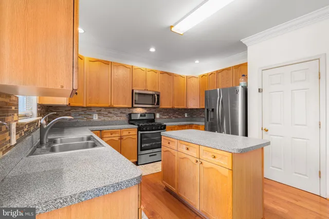 a bedroom with a large bed and two couches chair