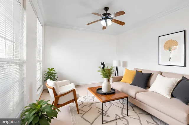 a dining room with furniture a chandelier and wooden floor