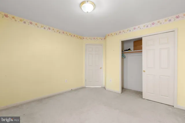 a front view of a house with a yard and parking space