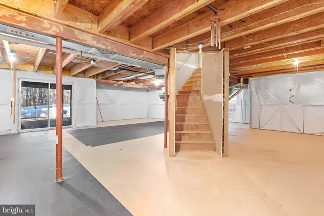 a view of a porch with wooden floor and iron fence