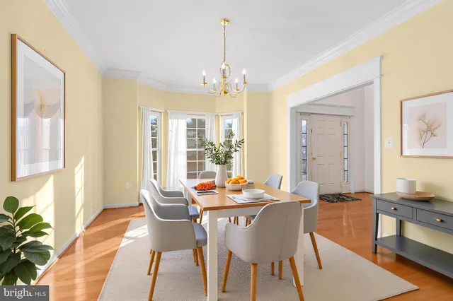 a dining room with stainless steel appliances kitchen island granite countertop a dining table chairs and granite counter tops