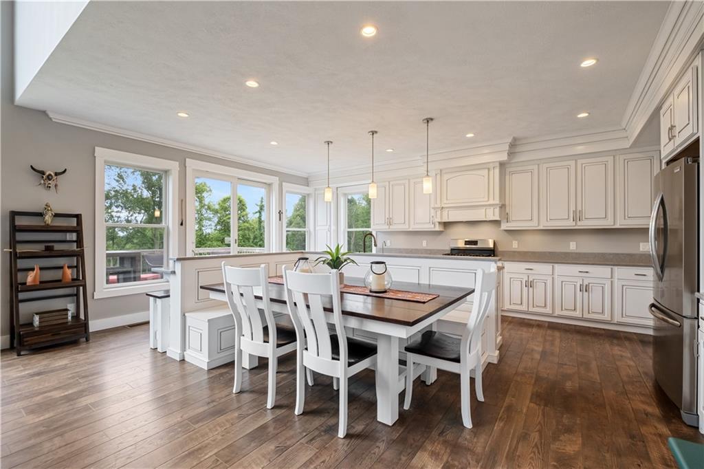 3396 5 Points Road Indiana, PA 15701 - Photo 15 of 49 a kitchen with stainless steel appliances granite countertop a stove top oven a dining table and chairs with wooden floor