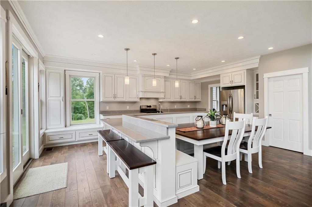 3396 5 Points Road Indiana, PA 15701 - Photo 16 of 49 a kitchen with a table chairs wooden floors and white cabinets