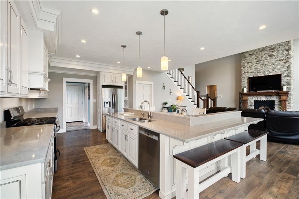 3396 5 Points Road Indiana, PA 15701 - Photo 20 of 49 a large white kitchen with stainless steel appliances kitchen island granite countertop a stove a sink a refrigerator and a fireplace