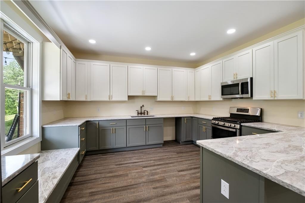 3396 5 Points Road Indiana, PA 15701 - Photo 40 of 49 a kitchen with granite countertop a stove top oven a sink dishwasher and a refrigerator with wooden floor