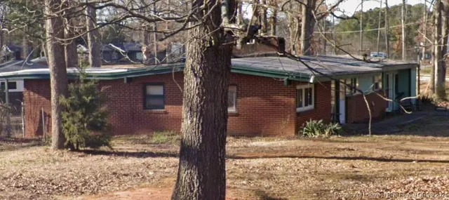 a backyard of a house with barbeque oven