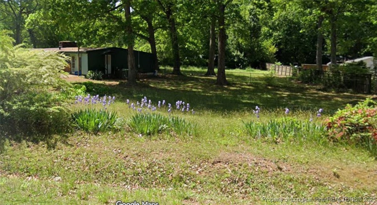 5813 Oak Forest Drive Raleigh, NC 27616 - Photo 5 of 10 a backyard of a house with lots of green space