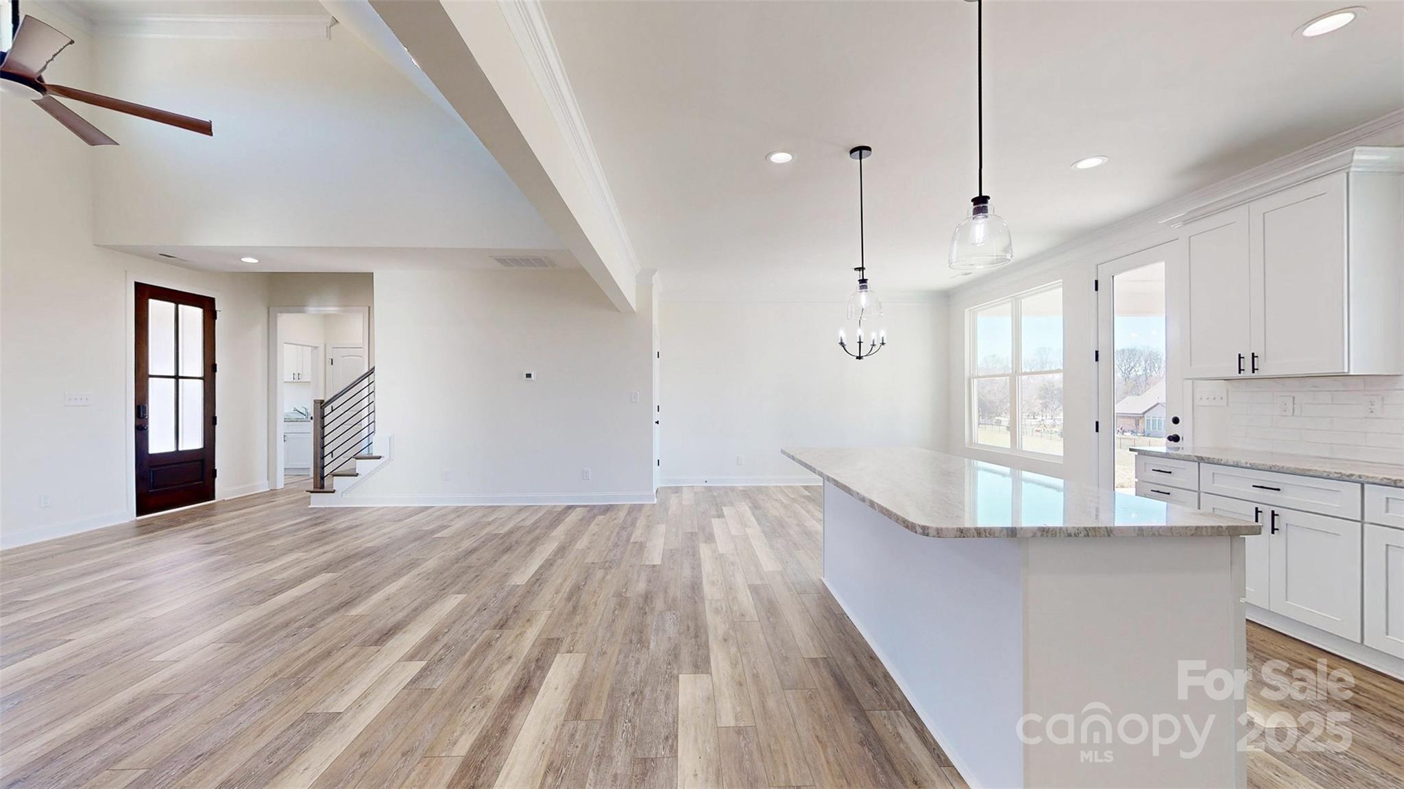 2906 Lathan Road Monroe, NC 28112 - Photo 12 of 41 a view of an empty room with wooden floor and a window