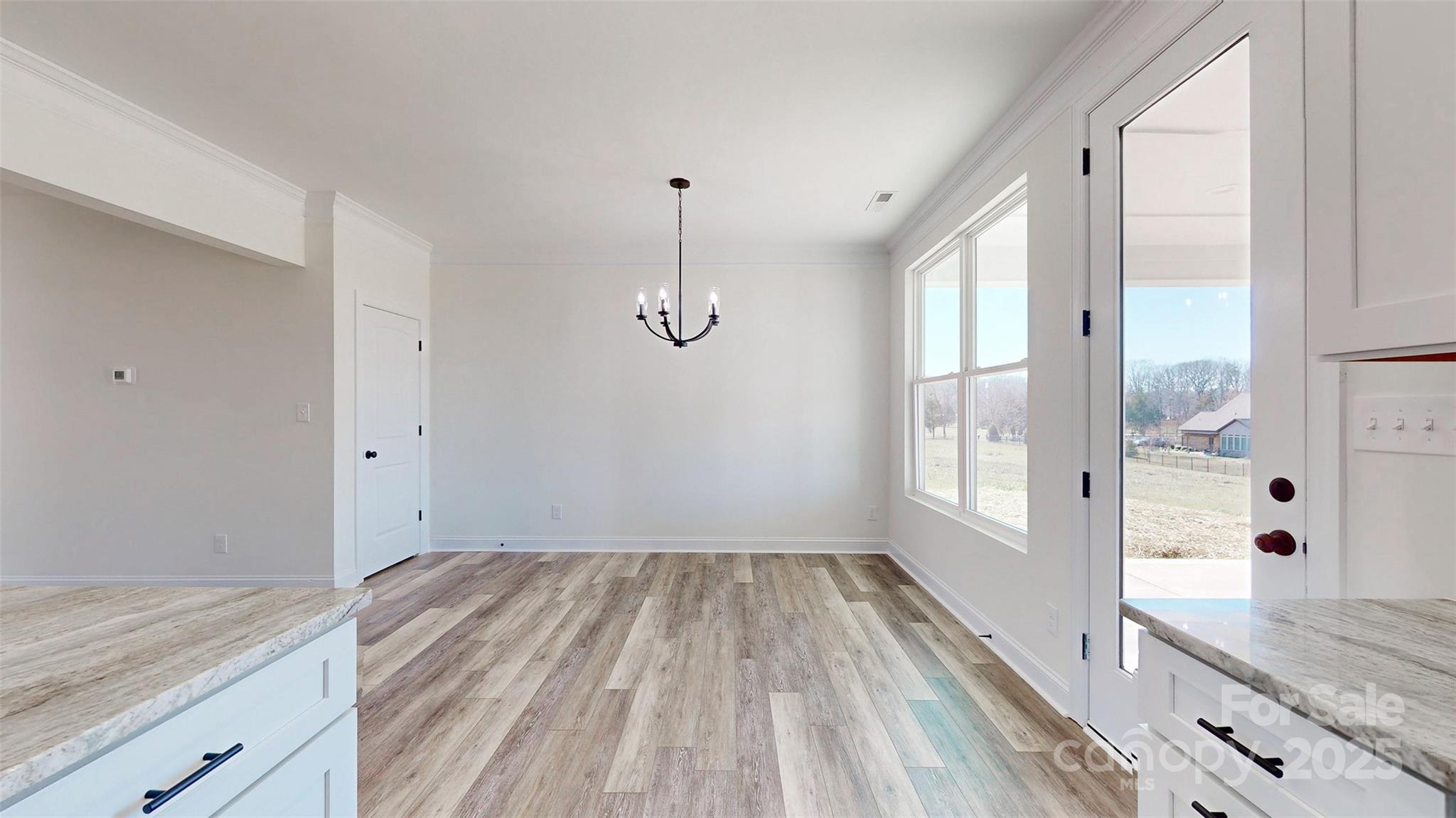 2906 Lathan Road Monroe, NC 28112 - Photo 22 of 41 a view of a kitchen with wooden floor and windows