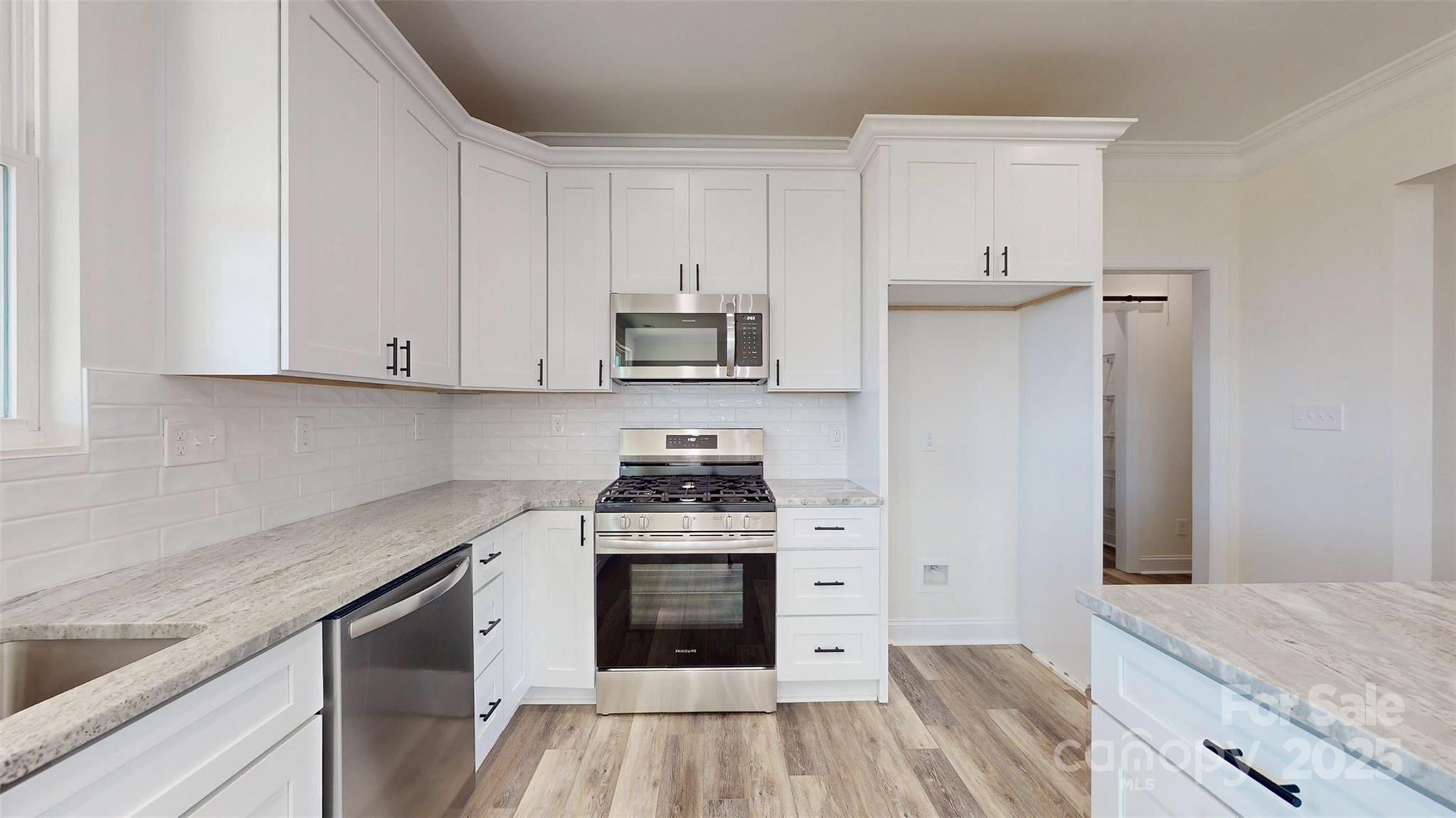 2906 Lathan Road Monroe, NC 28112 - Photo 23 of 41 a kitchen with stainless steel appliances granite countertop a stove and a sink