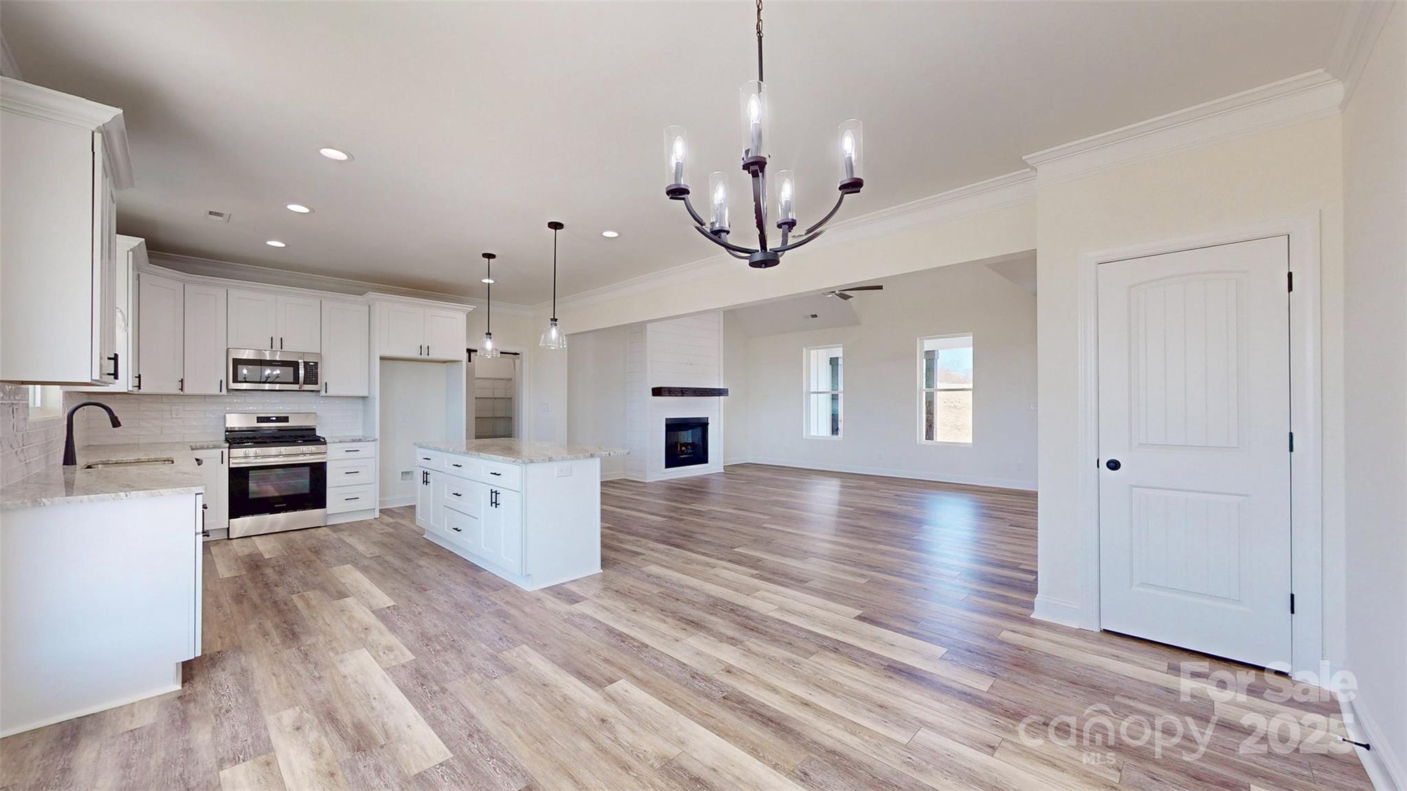 2906 Lathan Road Monroe, NC 28112 - Photo 25 of 41 a view of a kitchen with a sink stainless steel appliances and cabinets
