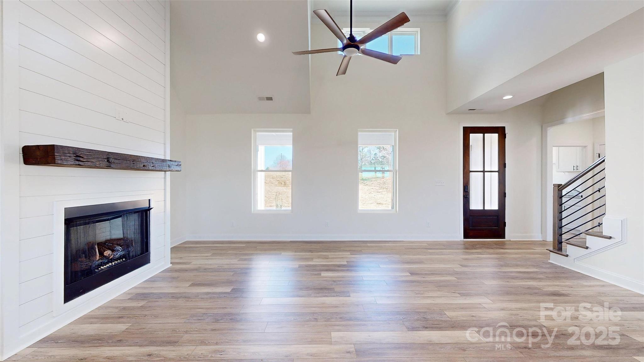 2906 Lathan Road Monroe, NC 28112 - Photo 28 of 41 a view of an empty room with wooden floor fireplace and a window