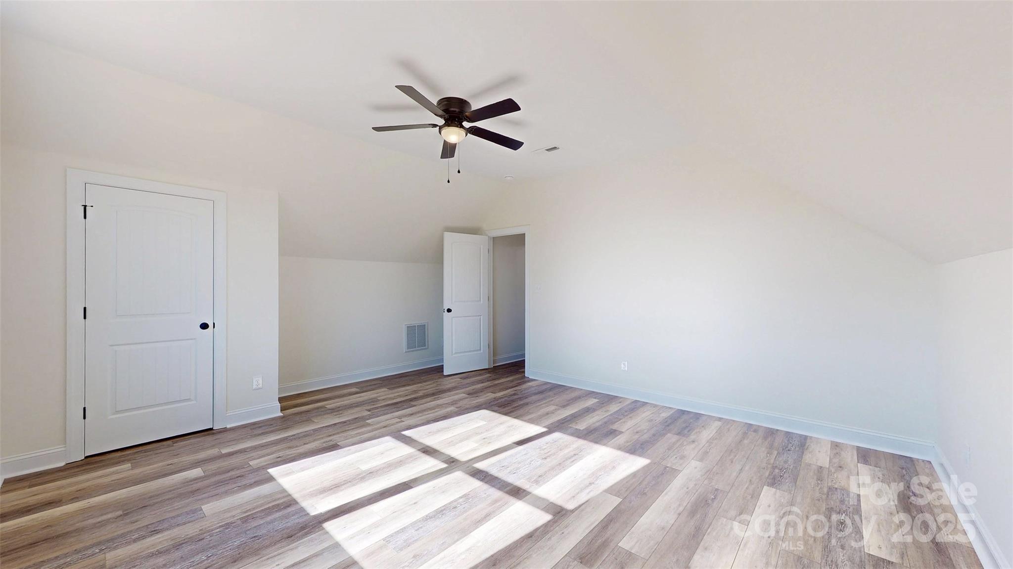 2906 Lathan Road Monroe, NC 28112 - Photo 3 of 41 a view of empty room with wooden floor and fan