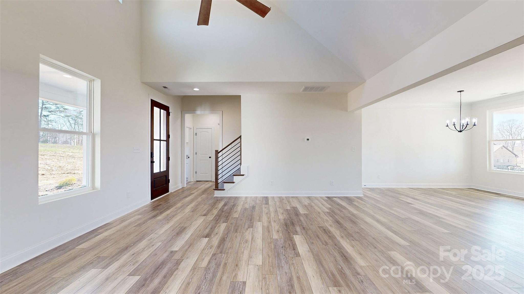 2906 Lathan Road Monroe, NC 28112 - Photo 32 of 41 a view of an empty room with wooden floor and a window