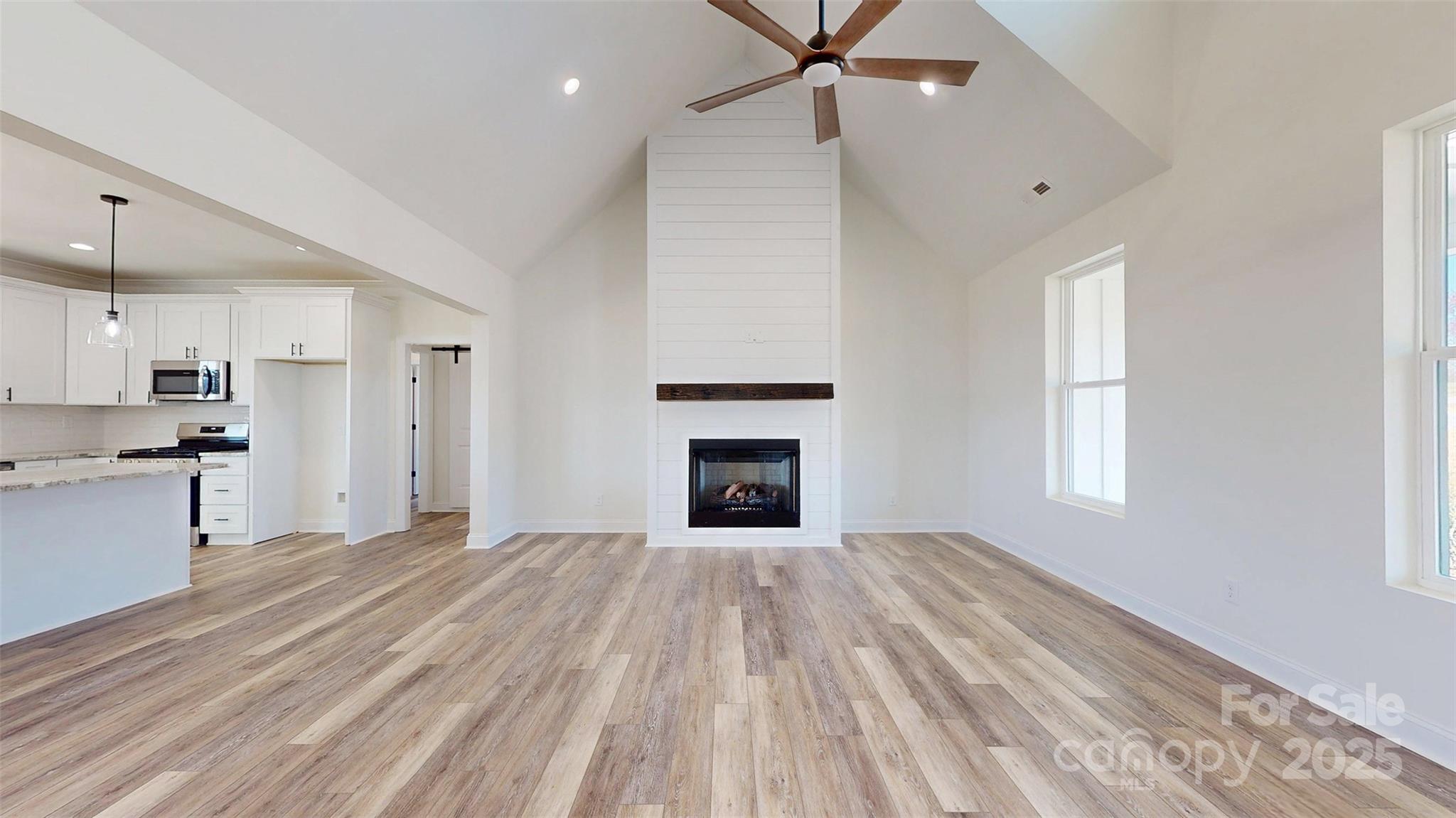 2906 Lathan Road Monroe, NC 28112 - Photo 33 of 41 a view of empty room with wooden floor and fireplace