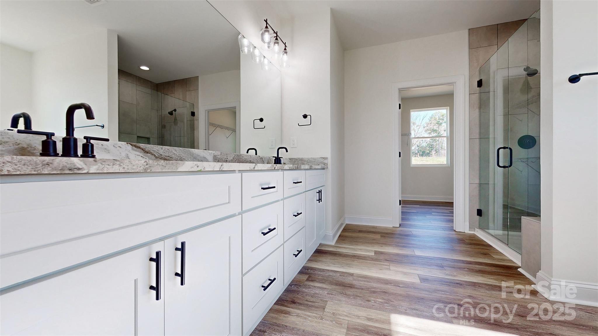 2906 Lathan Road Monroe, NC 28112 - Photo 8 of 41 a spacious bathroom with a double vanity sink and mirror