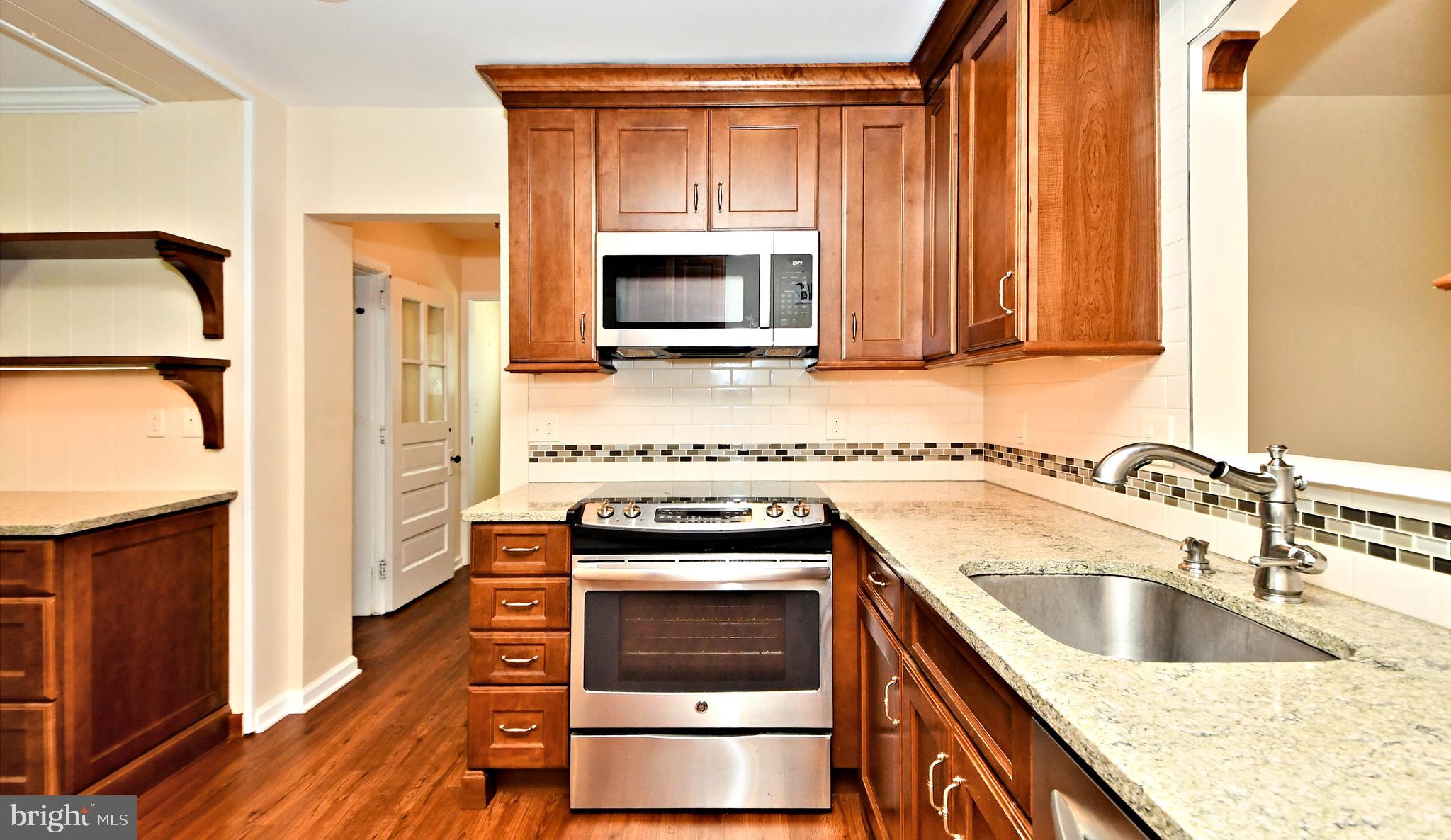 128 Garden Road Oreland, PA 19075 - Photo 8 of 32 Kitchen with granite counters and s/s appliances