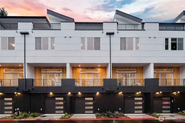 a front view of a building with lots of green space