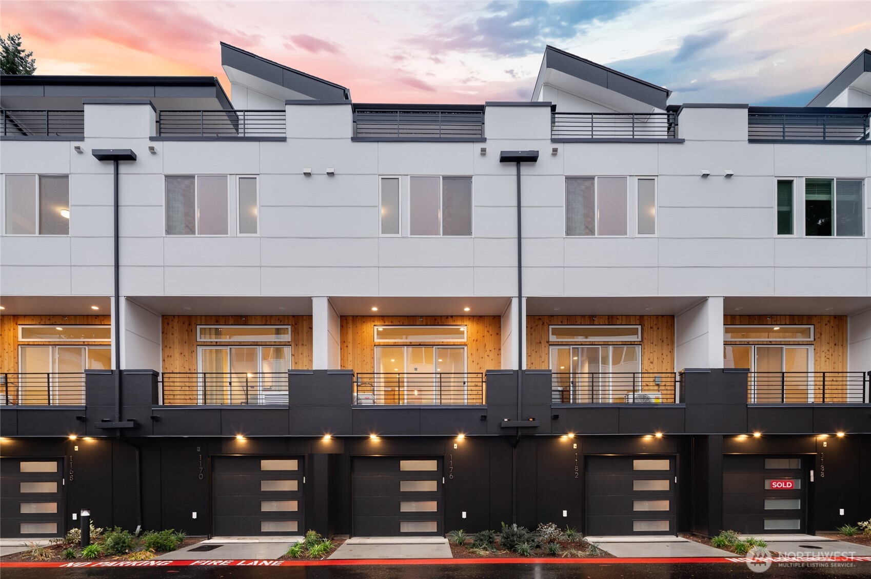 a front view of a building with lots of green space