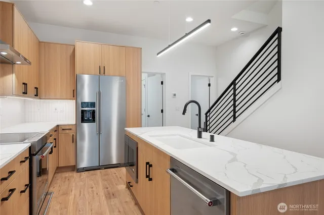 a kitchen with a sink a stove and refrigerator