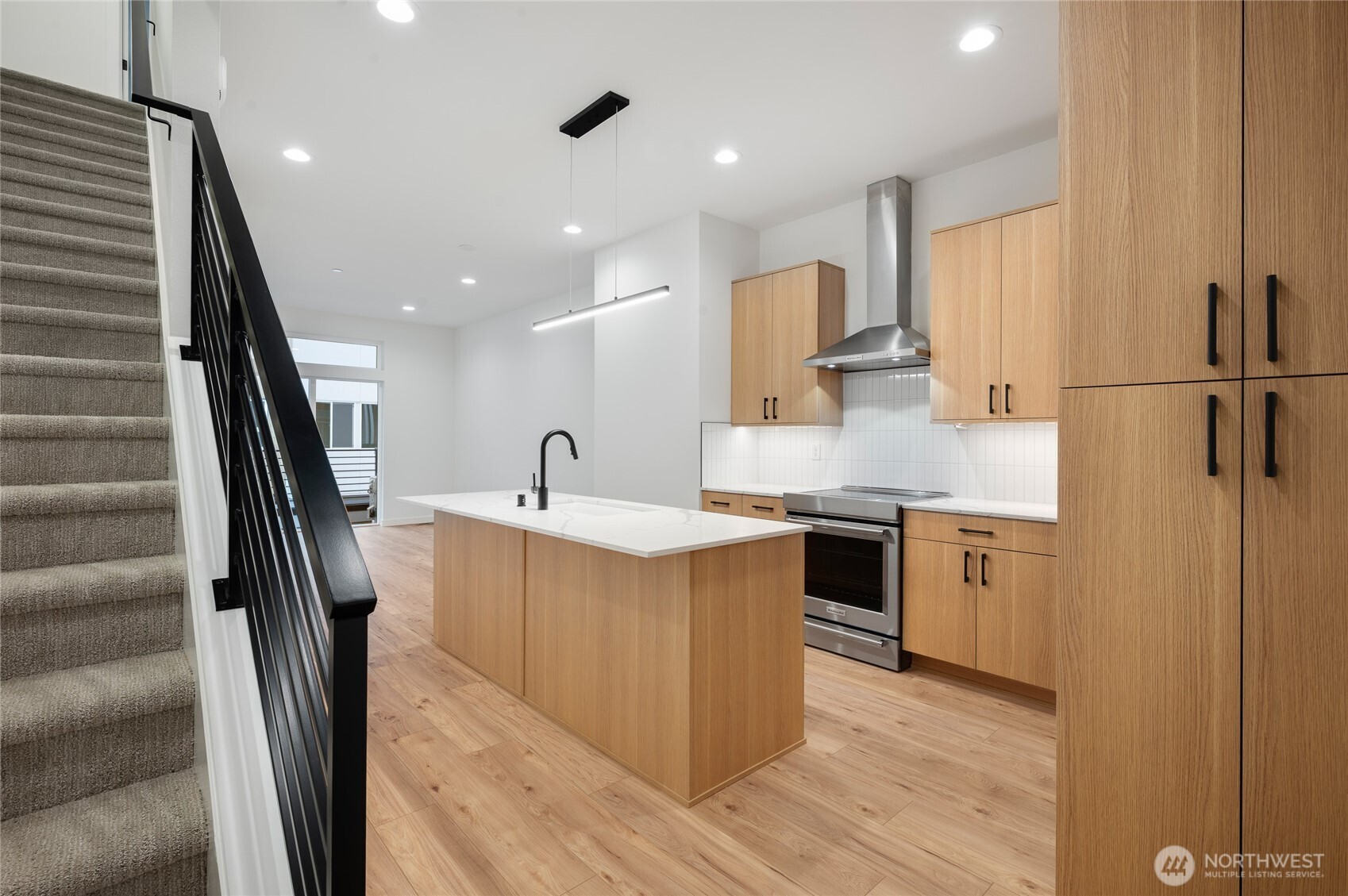 1176 129th Avenue Southeast Bellevue, WA 98005 - Photo 13 of 32 a kitchen with stainless steel appliances granite countertop a sink a stove a refrigerator and cabinets with wooden floor